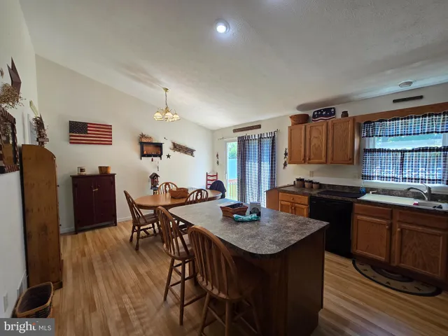 a kitchen with granite countertop a sink stove and refrigerator