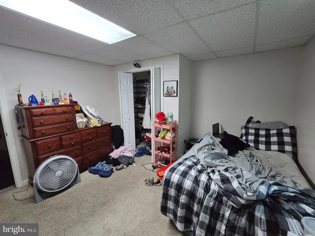 a bed room with a bed and a chair