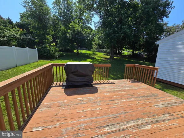 a view of table and chairs in patio with wooden fence