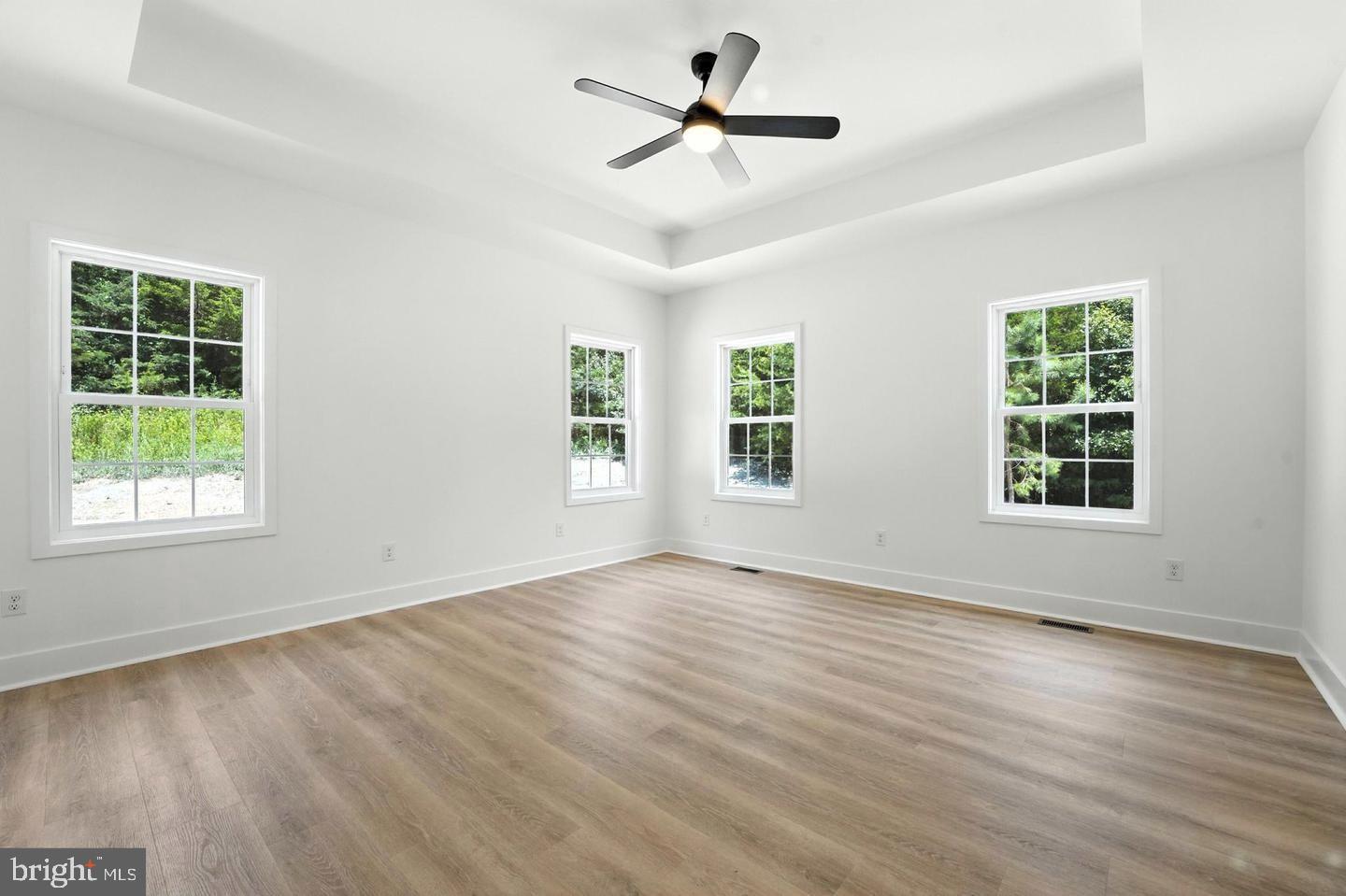 10704 Rixeyville Road Culpeper, VA 22701 - Photo 21 of 35 a view of an empty room with wooden floor and a window