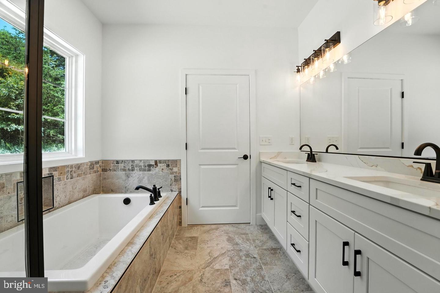 10704 Rixeyville Road Culpeper, VA 22701 - Photo 27 of 35 a bathroom with a tub sink and mirror