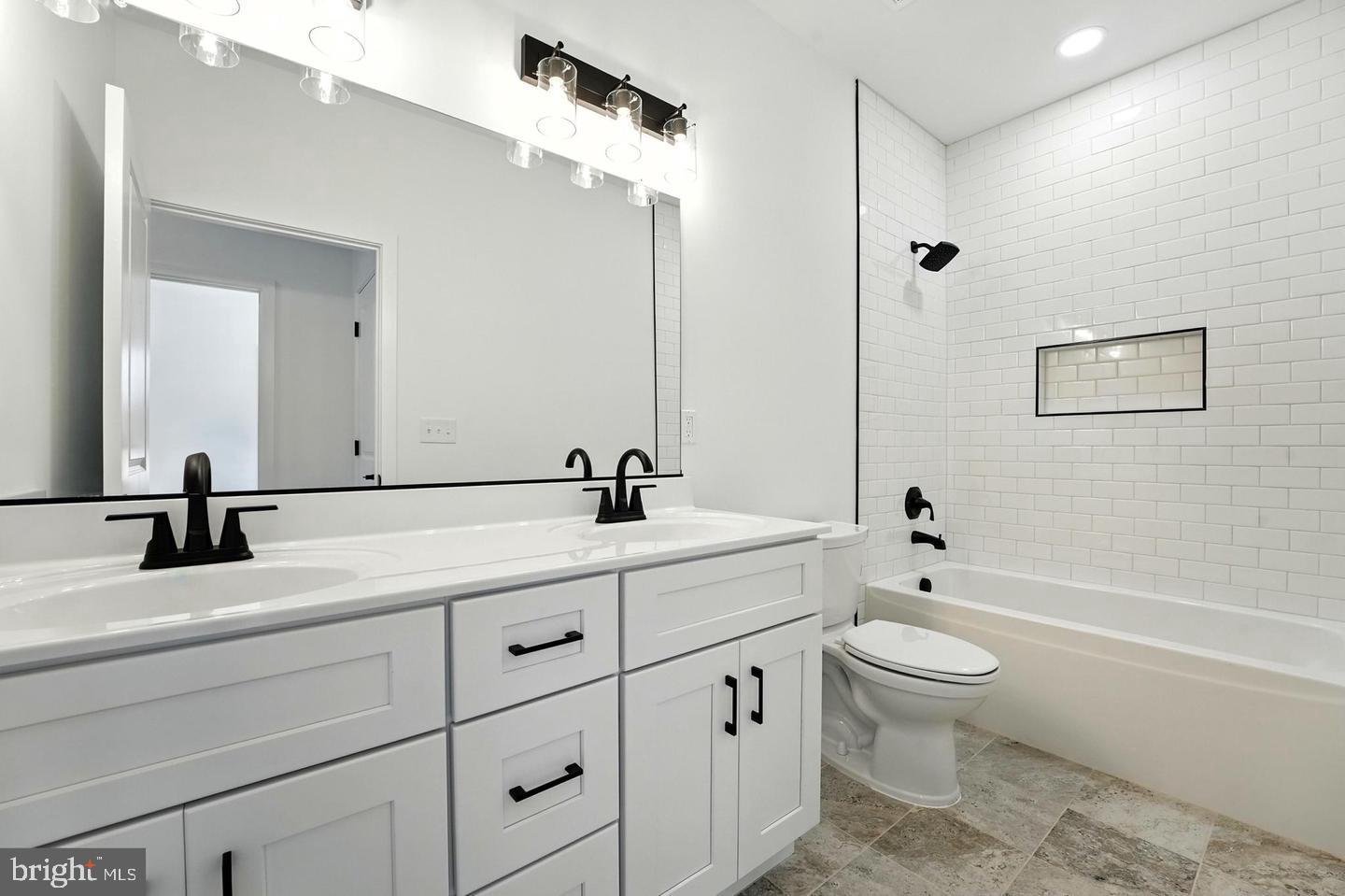 10704 Rixeyville Road Culpeper, VA 22701 - Photo 30 of 35 a bathroom with a double vanity sink a toilet and a bathtub