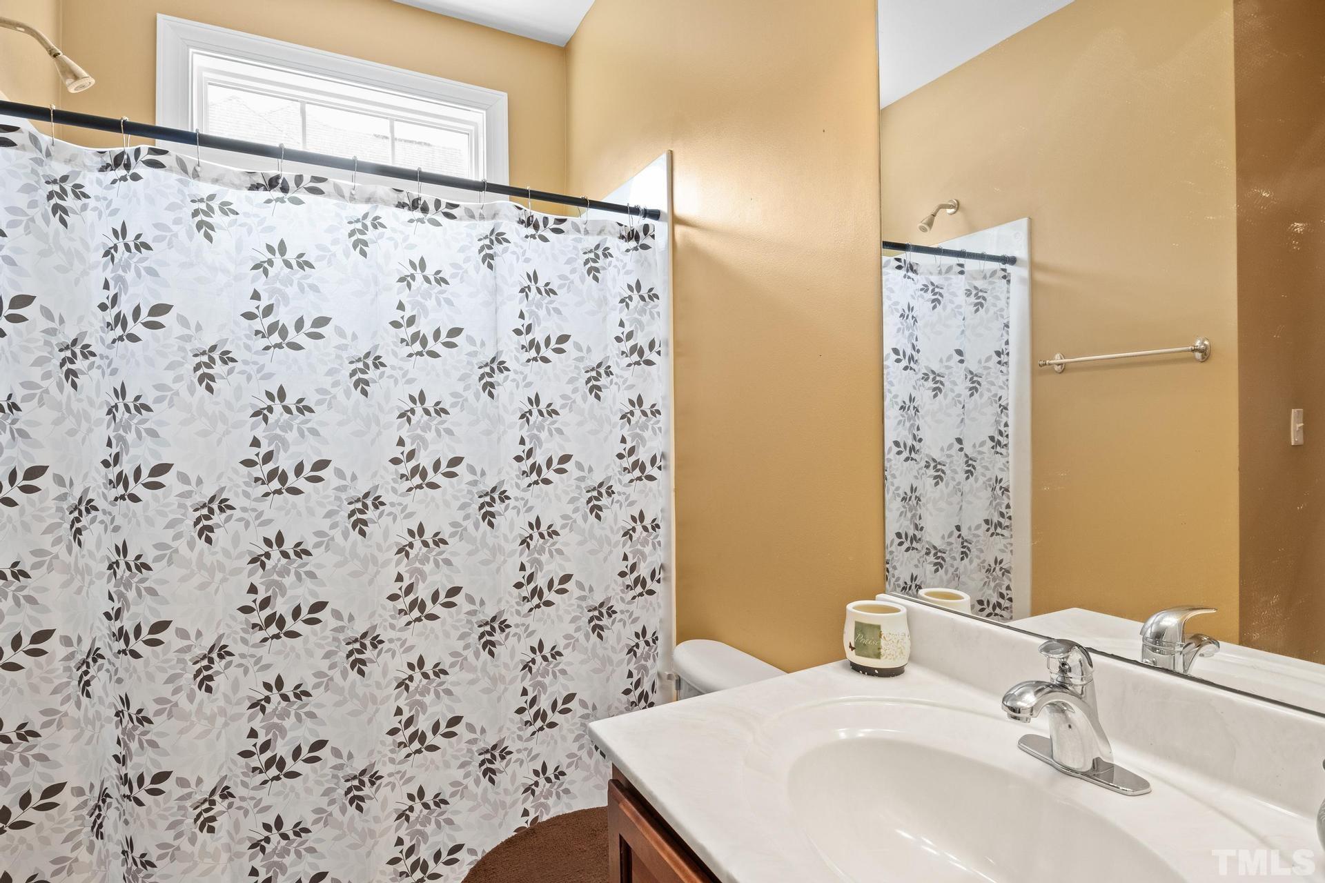 836 Crown Crossing Lane Raleigh, NC 27610 - Photo 23 of 31 a bathroom with a sink and a mirror