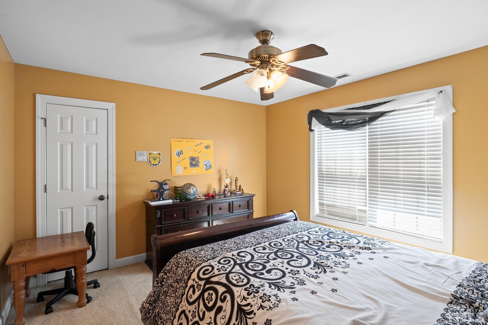 836 Crown Crossing Lane Raleigh, NC 27610 - Photo 28 of 31 a bedroom with a bed and a chandelier
