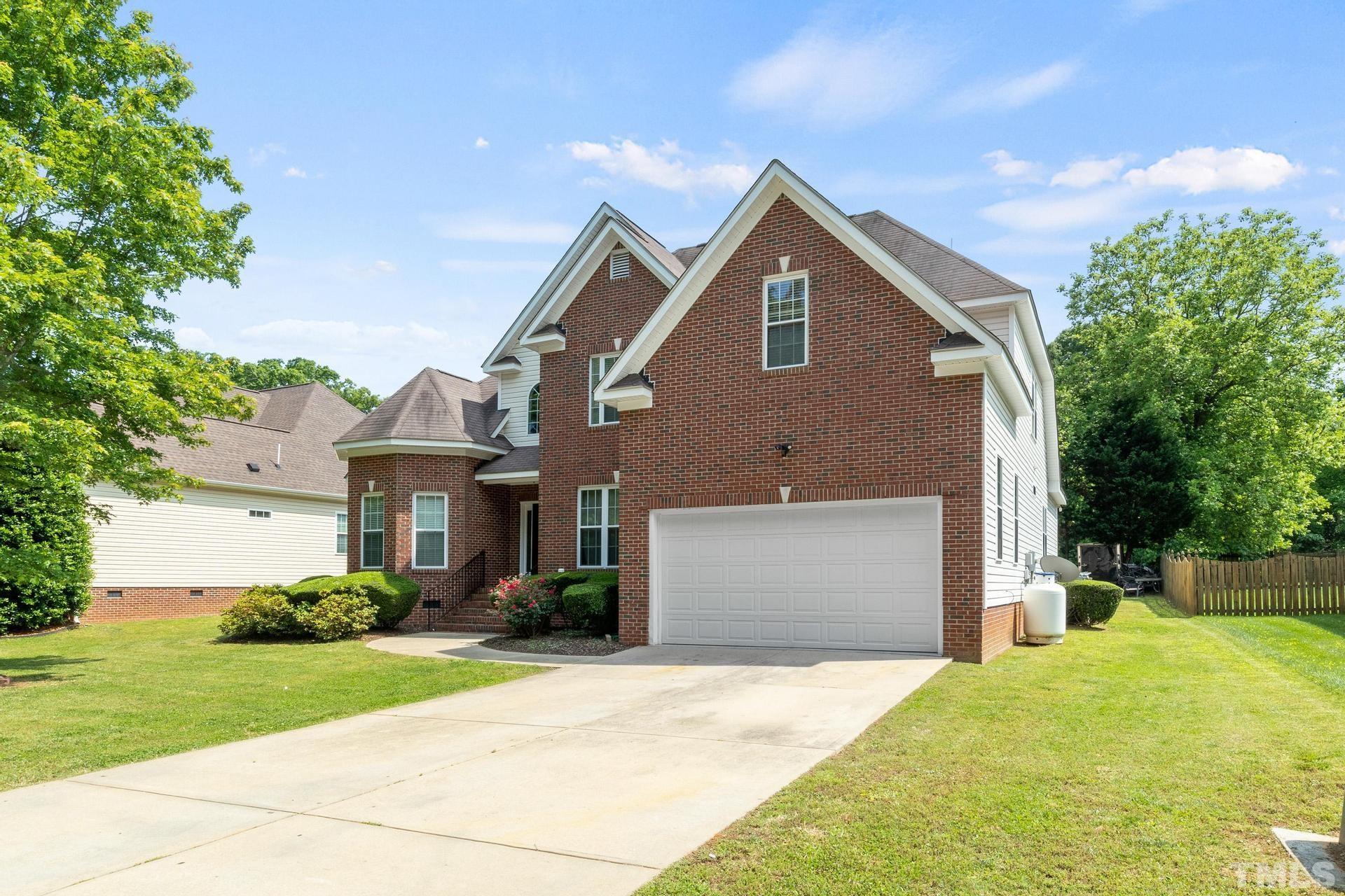 836 Crown Crossing Lane Raleigh, NC 27610 - Photo 3 of 31 a front view of a house with a yard and garage