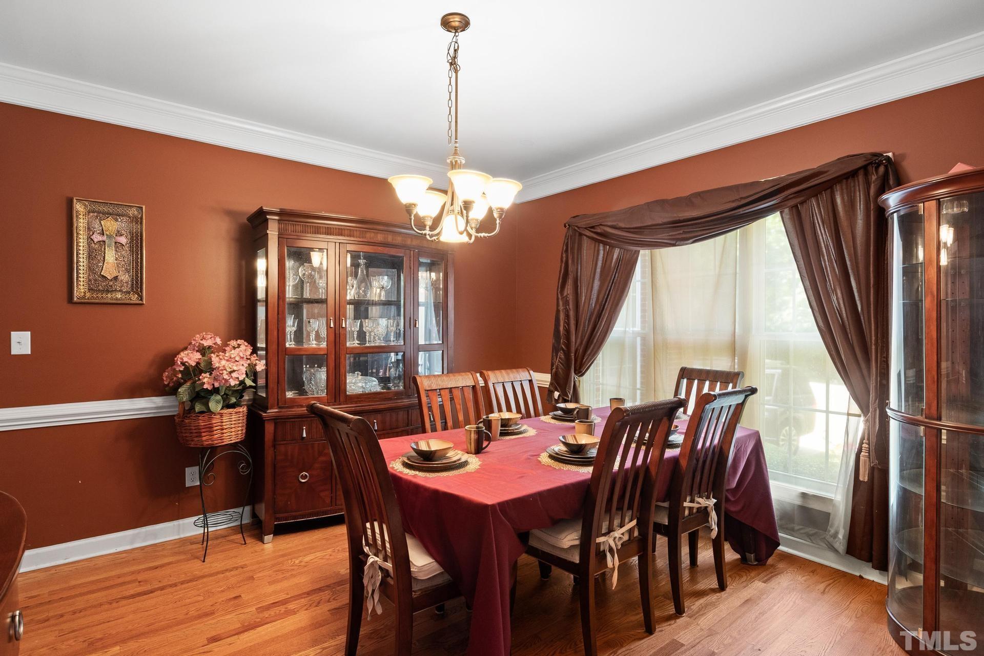 836 Crown Crossing Lane Raleigh, NC 27610 - Photo 8 of 31 a view of a dining room with furniture window and wooden floor