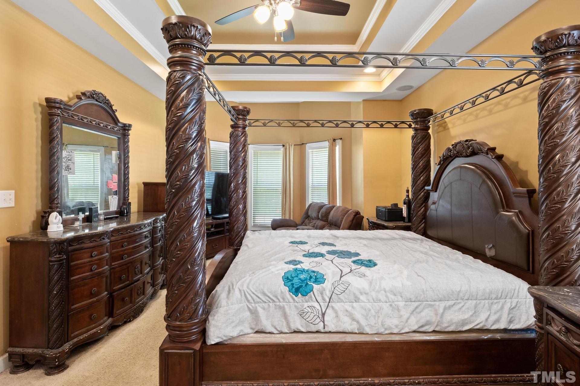 836 Crown Crossing Lane Raleigh, NC 27610 - Photo 10 of 31 a bedroom with a bed a mirror and furniture