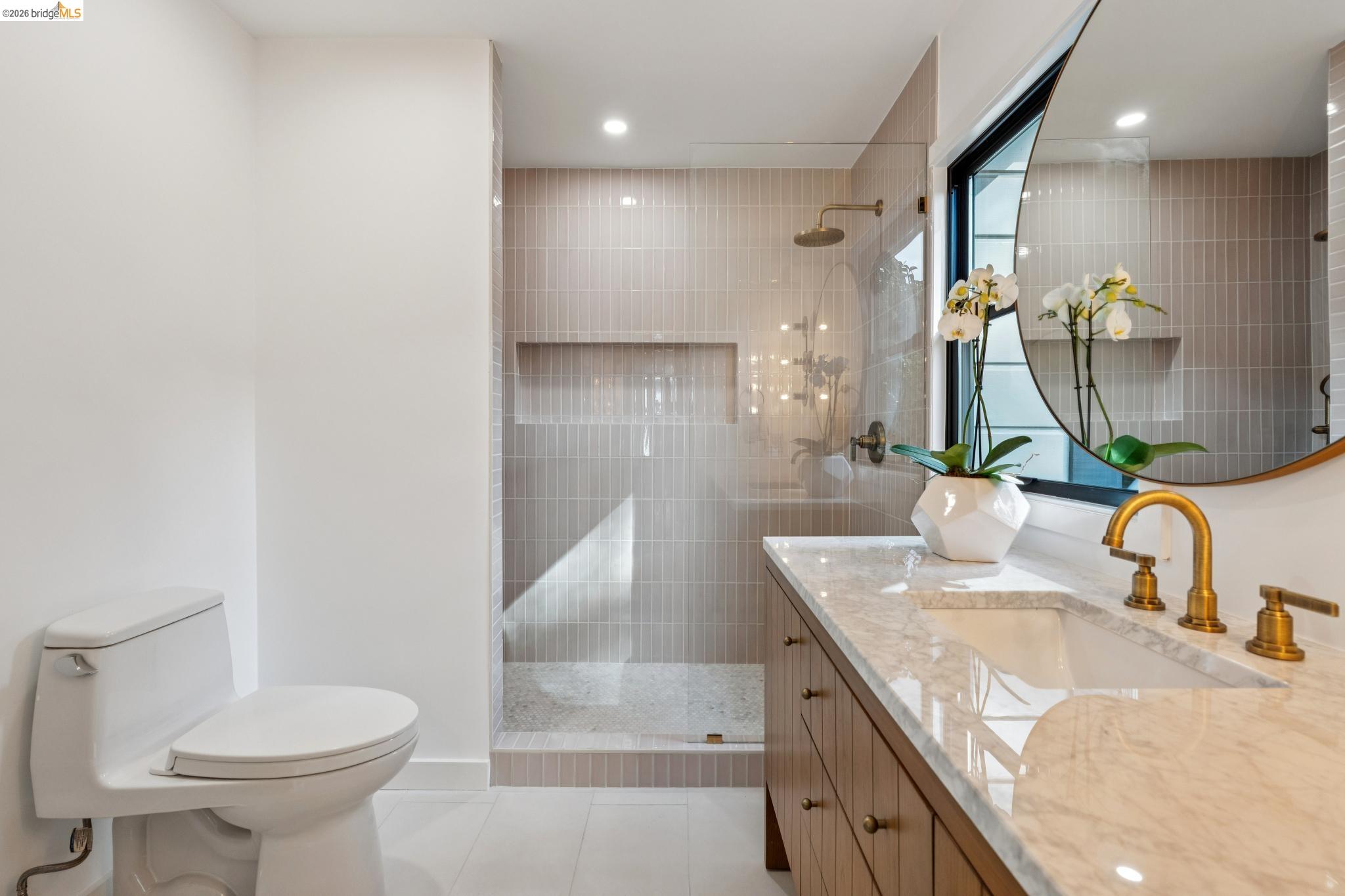 38 Highgate Road Kensington, CA 94707 - Photo 23 of 78 Vanity with a polished stone countertop and integrated sink, gold-finish faucet, and custom wood cabinetry