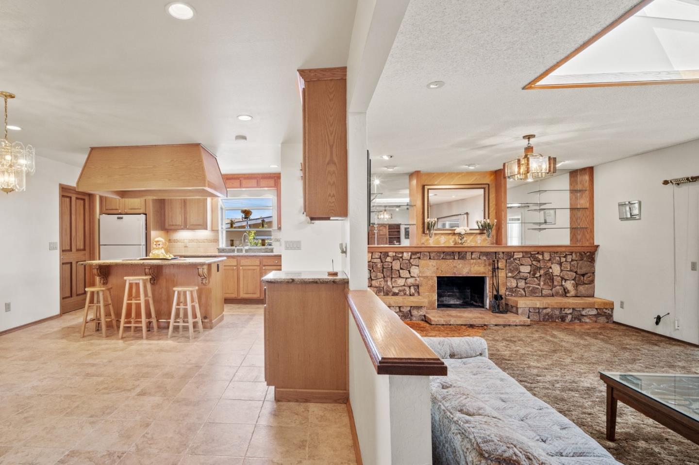 3060 Eddy Circle Marina, CA 93933 - Photo 3 of 35 a living room with furniture a fireplace and a kitchen view