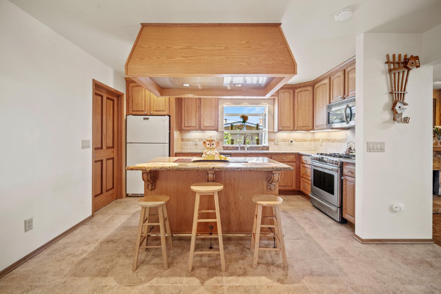 3060 Eddy Circle Marina, CA 93933 - Photo 7 of 35 a kitchen with stainless steel appliances granite countertop a stove a sink refrigerator and a microwave