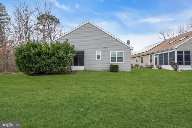 a front view of house with a garden