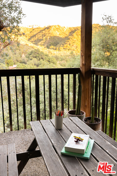 2690 Kennington Drive Glendale, CA 91206 - Photo 38 of 50 a balcony with wooden floor table and chairs