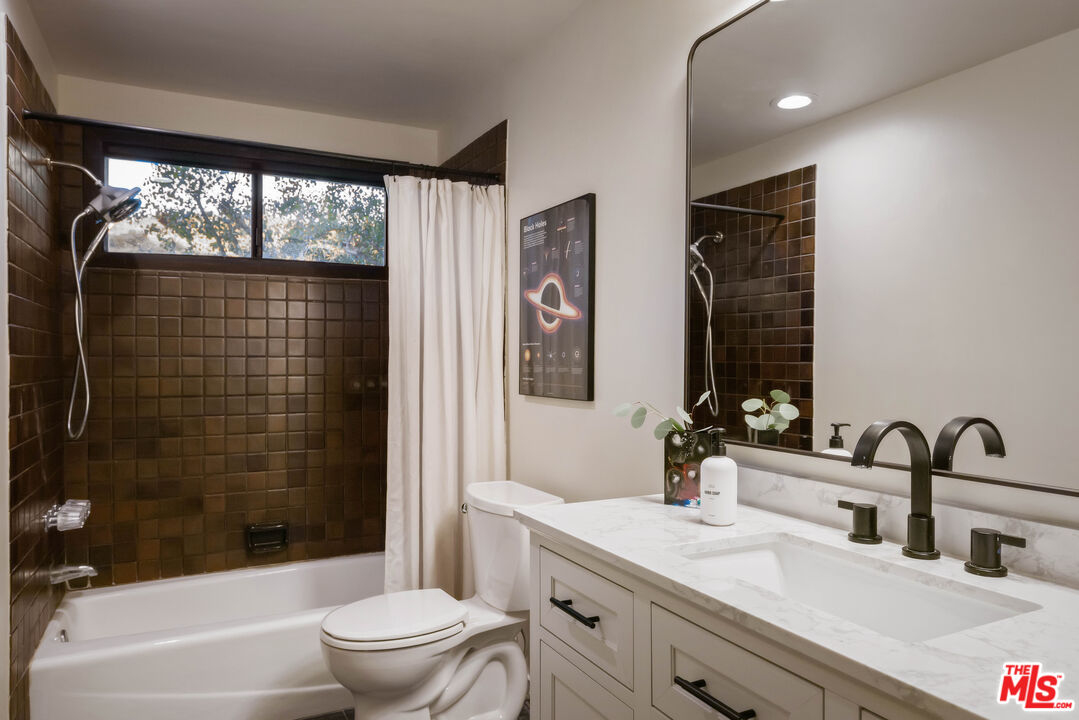 2690 Kennington Drive Glendale, CA 91206 - Photo 41 of 50 a bathroom with a double vanity sink toilet mirror and shower