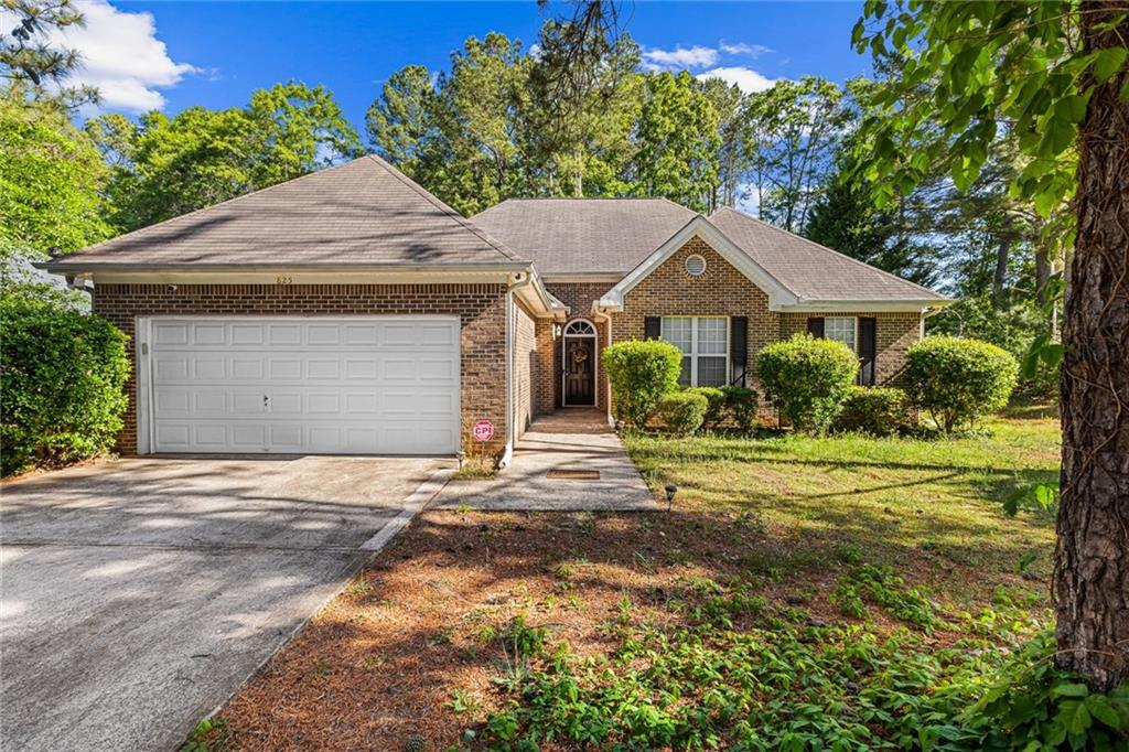 825 Lincoln Square Locust Grove, GA 30248 - Photo 1 of 29 a front view of a house with a yard and garage