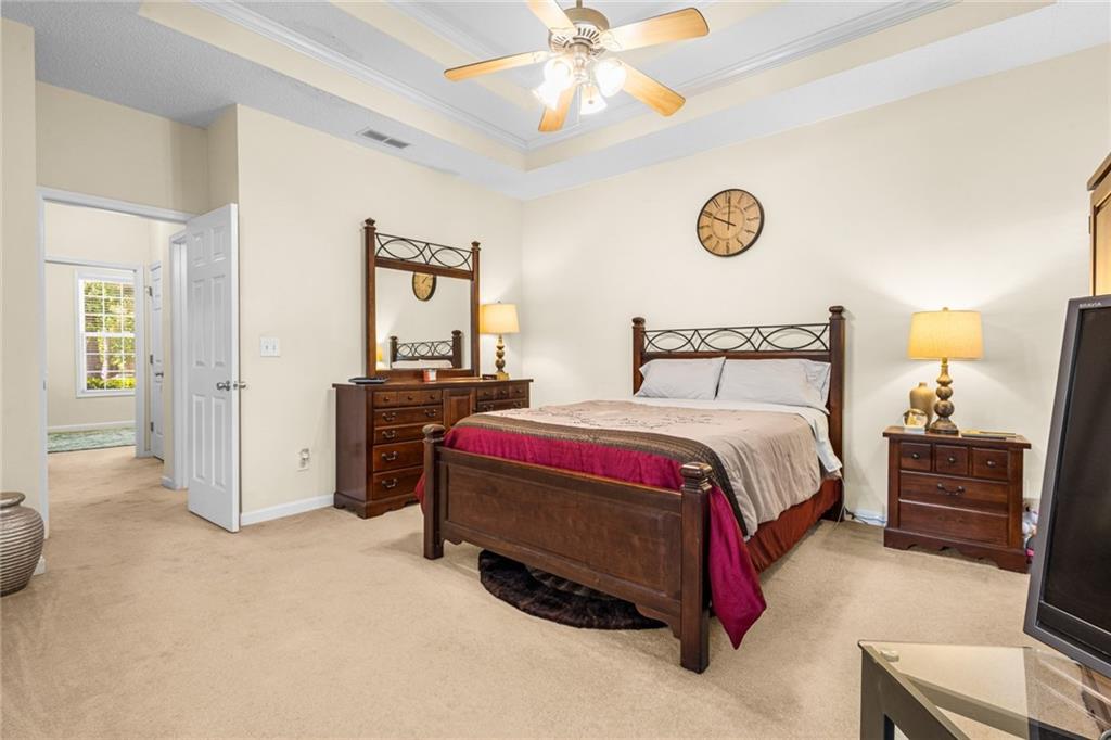 825 Lincoln Square Locust Grove, GA 30248 - Photo 16 of 29 a bedroom with a bed and a chandelier
