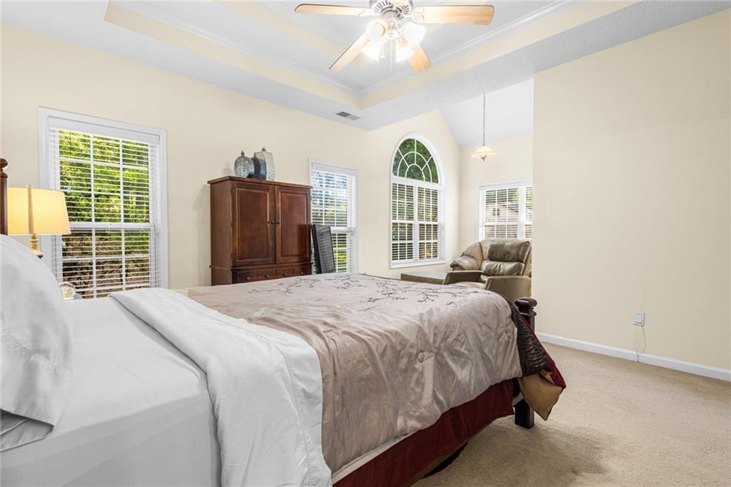 825 Lincoln Square Locust Grove, GA 30248 - Photo 17 of 29 a bedroom with a large bed and a large window