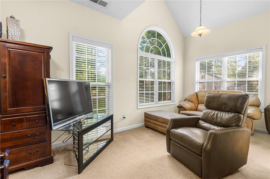 825 Lincoln Square Locust Grove, GA 30248 - Photo 18 of 29 a living room with furniture and a flat screen tv