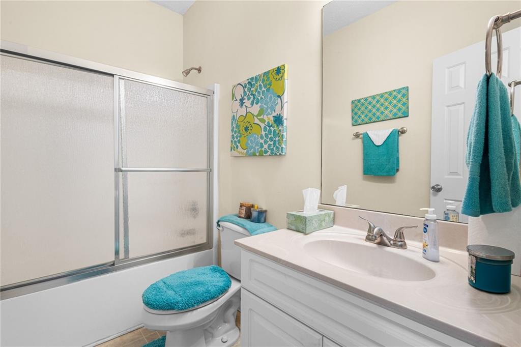 825 Lincoln Square Locust Grove, GA 30248 - Photo 25 of 29 a bathroom with a granite countertop sink mirror vanity and toilet