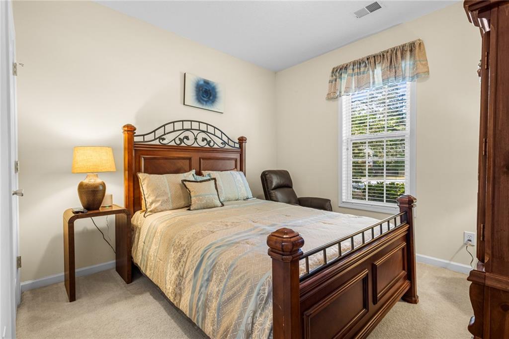 825 Lincoln Square Locust Grove, GA 30248 - Photo 26 of 29 a bedroom with a bed and a window