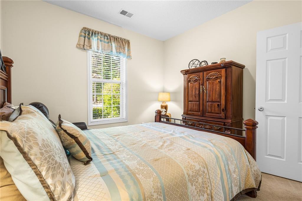 825 Lincoln Square Locust Grove, GA 30248 - Photo 27 of 29 a bedroom with a bed and a window