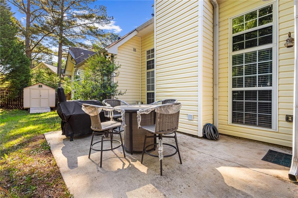 825 Lincoln Square Locust Grove, GA 30248 - Photo 28 of 29 a view of a patio with a table and chairs