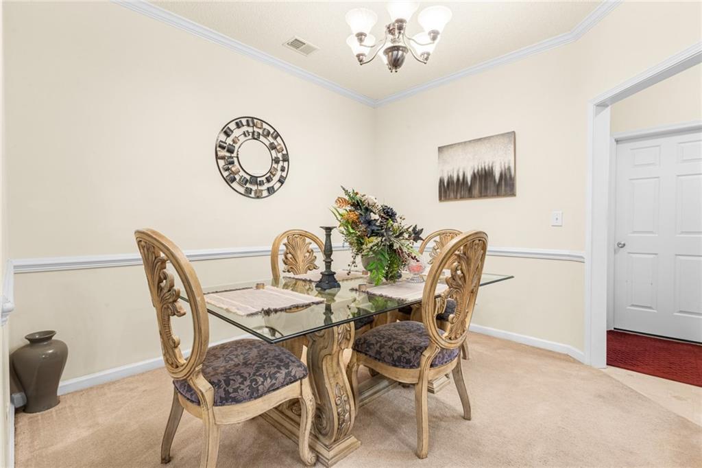 825 Lincoln Square Locust Grove, GA 30248 - Photo 6 of 29 a view of a dining room with furniture