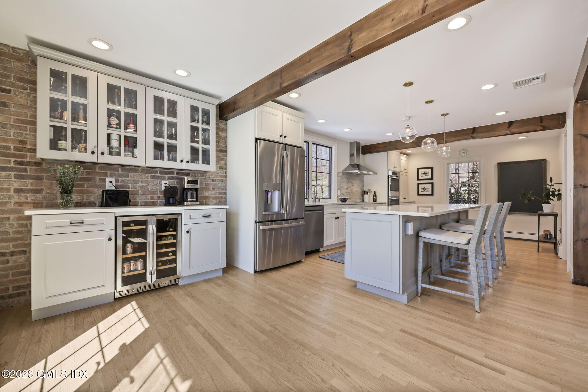97 Davenport Ridge Lane Stamford, CT 06903 - Photo 13 of 31 a kitchen with stainless steel appliances kitchen island granite countertop a stove top oven a sink a dining table and chairs