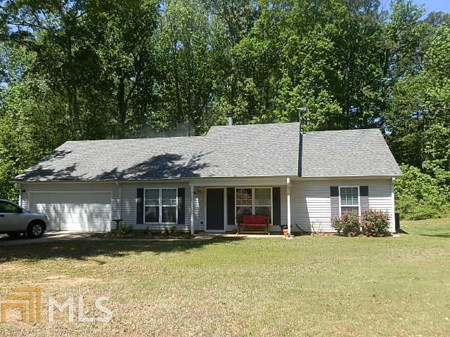 110 Springvalley Circle Stockbridge, GA 30281 - Photo 1 of 1 a front view of a house with a yard table and chairs