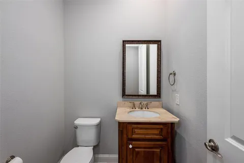a bathroom with a sink toilet and vanity