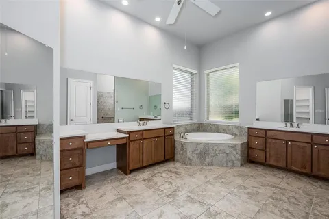 a large bathroom with a large tub and sink