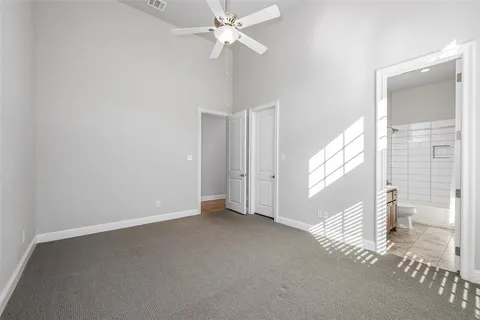 a view of a livingroom with a ceiling fan and window