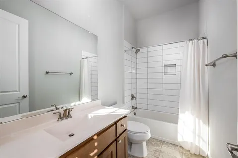 a bathroom with a sink toilet tub and shower