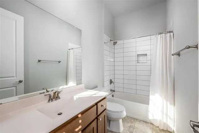 a bathroom with a sink toilet tub and shower