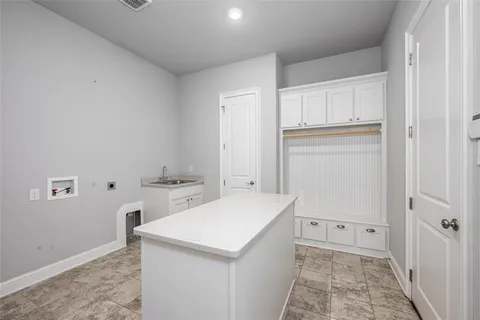 a view of a kitchen with white cabinets