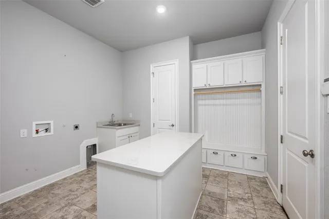 a view of a kitchen with white cabinets