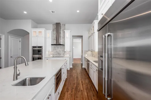 a kitchen with a sink and refrigerator