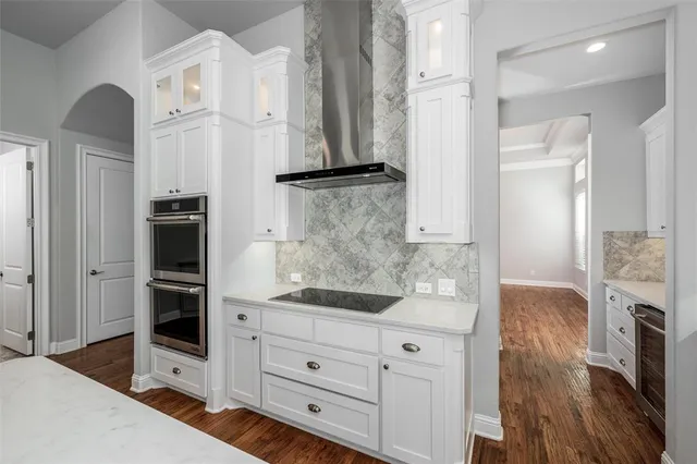a kitchen with stainless steel appliances granite countertop a refrigerator and a stove