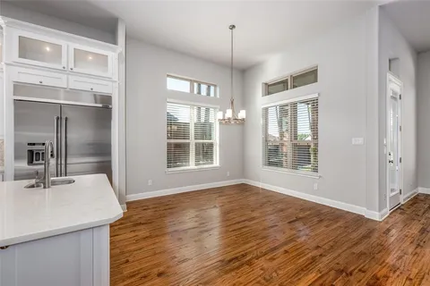 a view of wooden floor and windows in a room