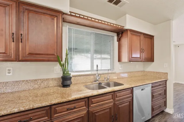 a kitchen with stainless steel appliances granite countertop a stove and a sink