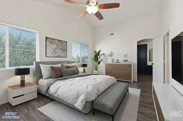 a view of an empty room with a fireplace and wooden floor
