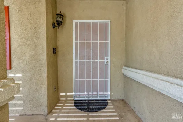 an empty room with wooden floor fireplace and windows