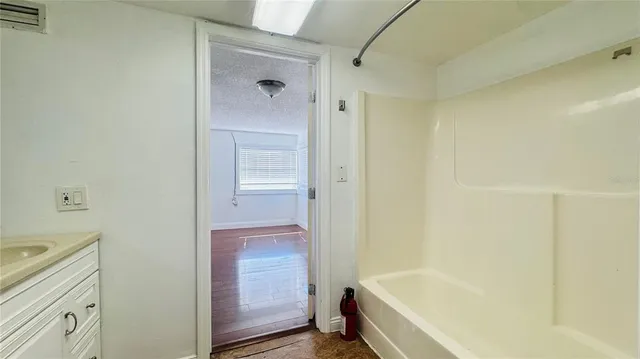 a bathroom with a bathtub and shower