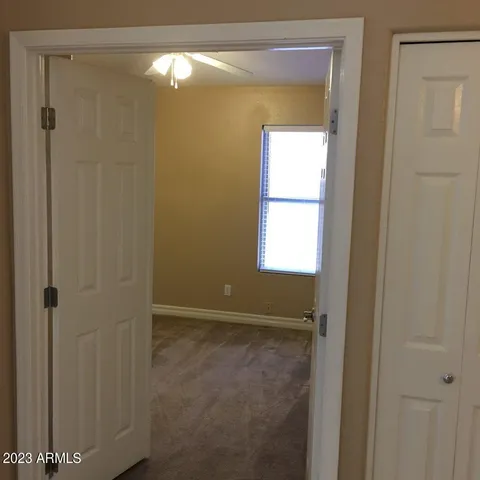 a view of an empty room with closet area