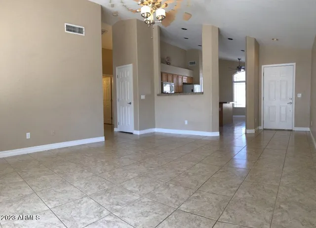 a view of a hallway with wooden floor and a chandelier