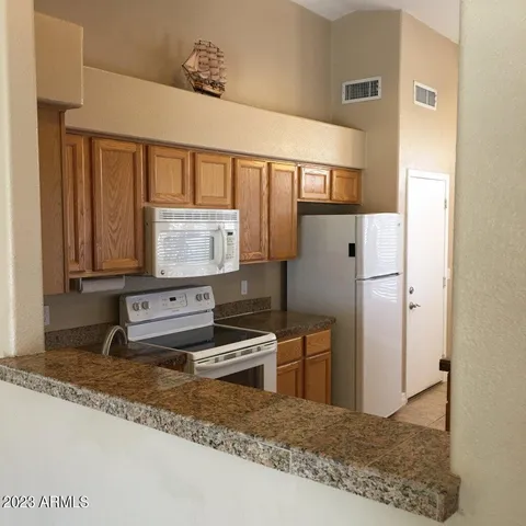 a kitchen with stainless steel appliances granite countertop a refrigerator and a sink