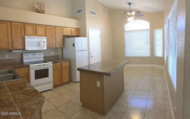 a kitchen with stainless steel appliances a stove a sink and a refrigerator
