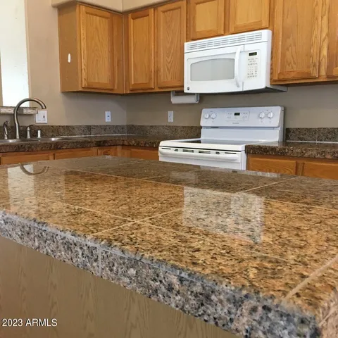 a kitchen with stainless steel appliances granite countertop a sink a stove and a microwave