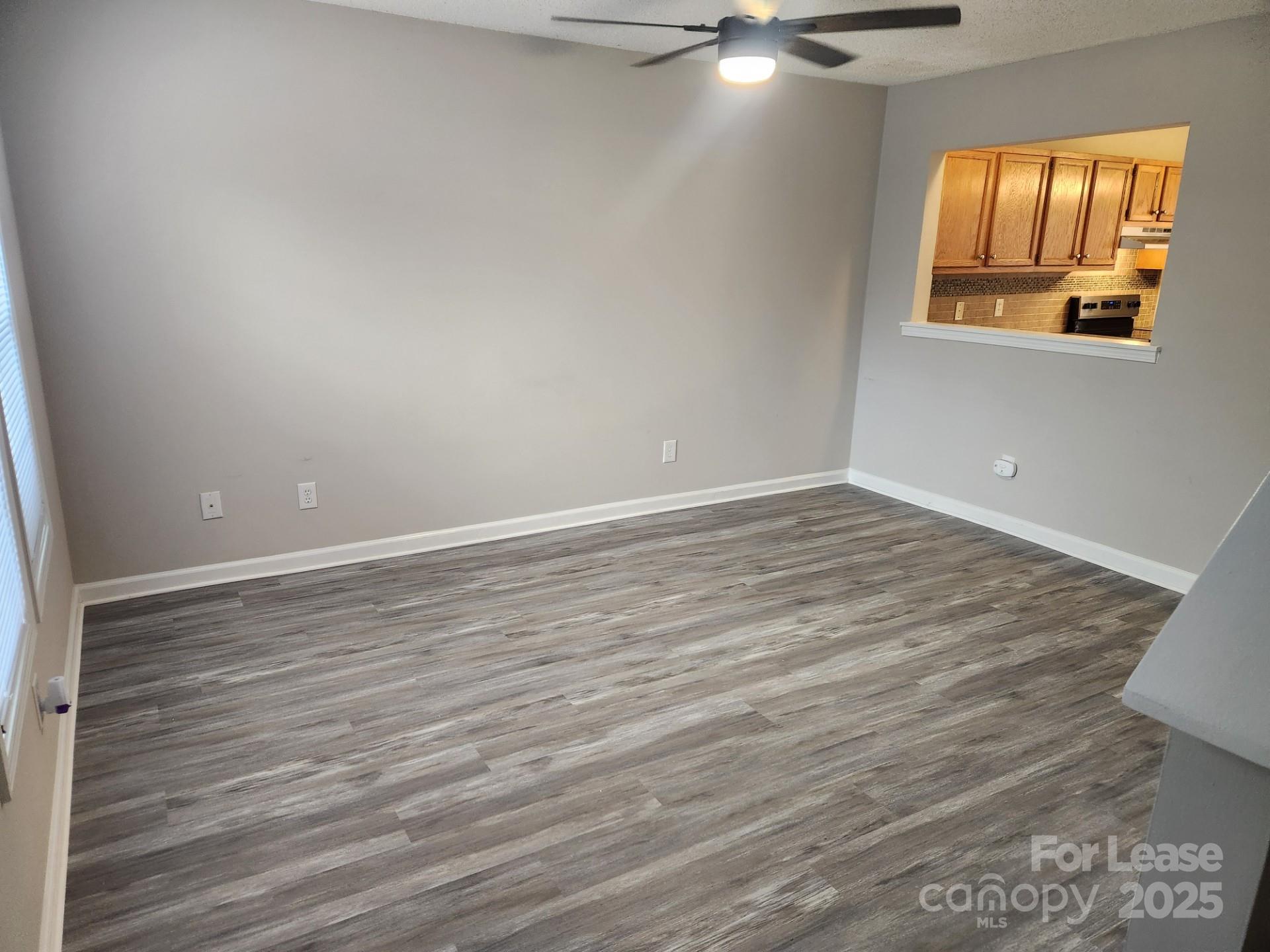 157 Pounds Avenue Southwest Concord, NC 28025 - Photo 13 of 15 wooden floor in an empty room with a window