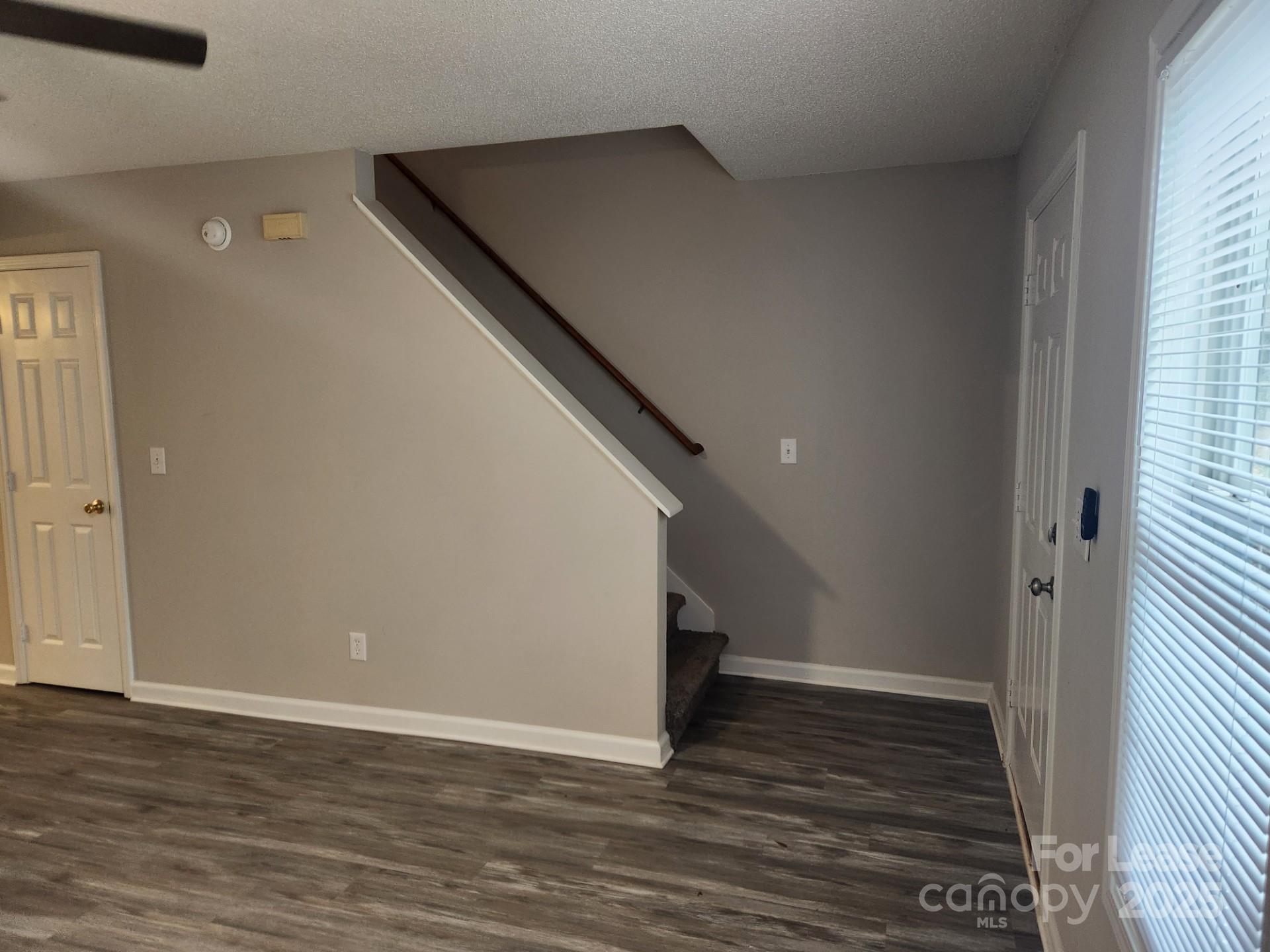 157 Pounds Avenue Southwest Concord, NC 28025 - Photo 14 of 15 a view of a hallway with wooden floor and staircase