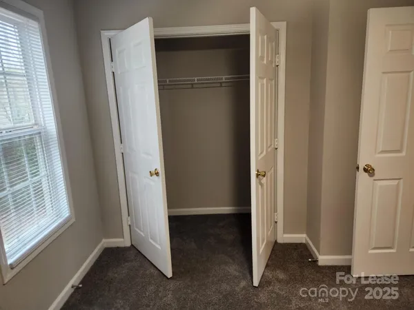 a view of entryway with refrigerator and cabinet